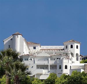 a large white building with trees in front of it at Villa Guadalupe in Málaga