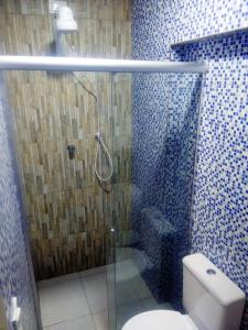 a bathroom with a glass shower with a toilet at Pousada Itararé in Campina Grande +19 photos