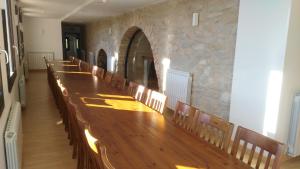 a long wooden table and chairs in a room at Albergue de Benabarre-CALUMET in Benabarre