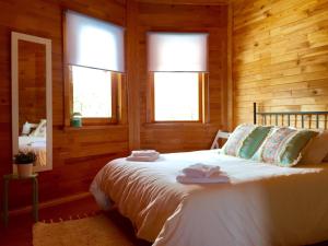 a bedroom with a bed with two towels on it at Casita de madera in Benicarló