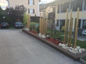 un jardín con valla de bambú y rocas en una entrada en Gite de la Robella, en Buttes