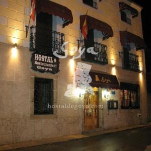 a building with signs on the side of it at Hostal Restaurante Goya in Piedrahita