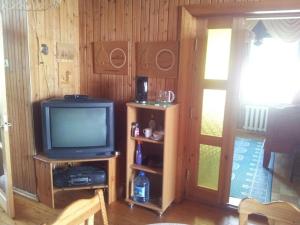 a living room with a television and a door at Eha Suija Home Accommodation in Tartu