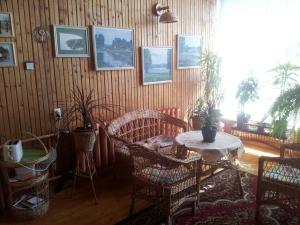 a living room with a table and chairs and a table at Eha Suija Home Accommodation in Tartu