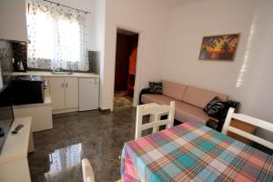 a small apartment with a couch and a kitchen at Mihal Suites in Sarandë