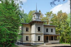 an old house with a tower on top of it at Villa Santa in Cēsis