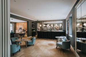 a restaurant with blue chairs and a bar at Villa Santa in Cēsis