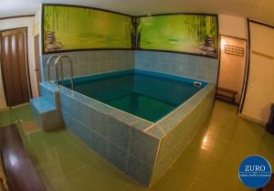 a large swimming pool in a room with an aquarium at Hotel Best-Zuro in Ulyanovsk