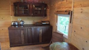 a kitchen with a wooden bar in a cabin at Domki nad Soliną in Olchowiec +25 photos