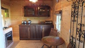 a kitchen with a wooden counter and a table at Domki nad Soliną in Olchowiec