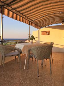 a table and chairs with a view of the ocean at Pinta Apartments in Lumbarda