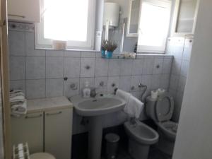 a bathroom with a sink and a toilet at Apartment Hela in Zadar +9 photos