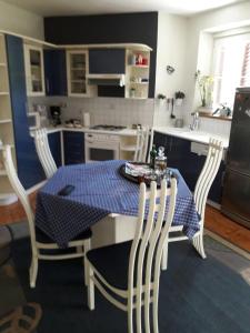 a kitchen with a table with a blue and white table and chairs at Apartment Hela in Zadar