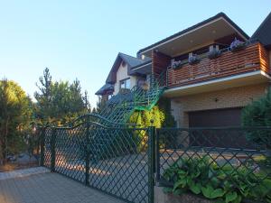 a house with a staircase on the side of it at Apartments Ąžuolas in Palanga