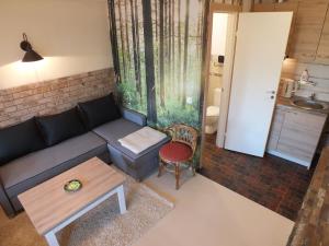 a living room with a couch and a table at Apartments Ąžuolas in Palanga