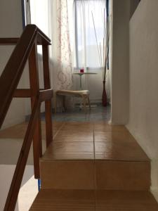 a staircase in a room with a chair and a window at Tranquilo y Acogedor Apartamento in Órzola