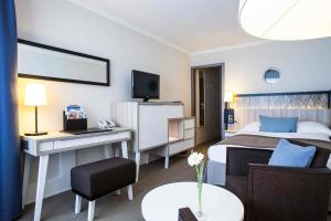 Uma TV ou centro de entretenimento em Hotel Neptun