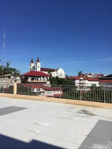 a view of a city with a fence and buildings at Umali Kayo at Megatower Residences II in Baguio