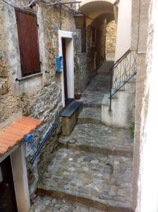 an alley with stairs and a door and a building at Casa Vacanze Storica in Seborga