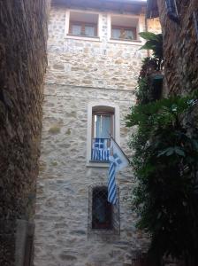 a stone building with a window with a blue cross at Casa Vacanze Storica in Seborga