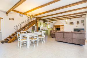 a kitchen and living room with a table and chairs at Holiday house Hojevica - Kras, Krk in Kras