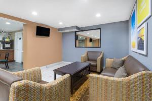a waiting room with couches and a table at Days Inn by Wyndham Newberry South Carolina in Newberry