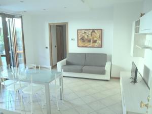 a living room with a glass table and a couch at Casa Vacanze Marone in Marone