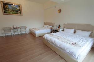 Postel nebo postele na pokoji v ubytování Jin Du Yi Yuan B & B