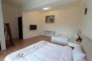 Postel nebo postele na pokoji v ubytování Jin Du Yi Yuan B & B