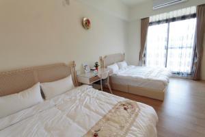 Postel nebo postele na pokoji v ubytování Jin Du Yi Yuan B & B