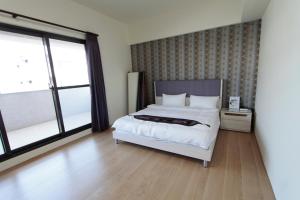 Postel nebo postele na pokoji v ubytování Jin Du Yi Yuan B & B