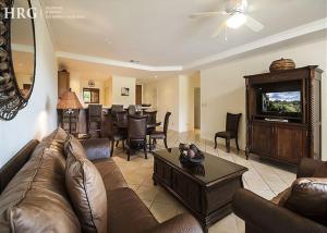 a living room with a couch and a dining room at Ocean View Condo in Los Sueños in Herradura