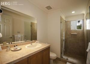 a bathroom with a sink and a toilet and a shower at Ocean View Condo in Los Sueños in Herradura