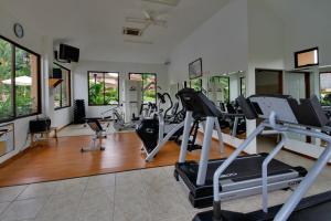 a gym with treadmills and ellipticals in a room at Ocean View Condo in Los Sueños in Herradura