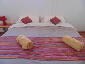 a bed with two towels on top of it at Magic Cusco in Cusco +20 photos