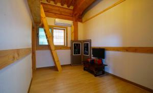 an empty room with a room with a television and a room with a room at The Mumum Guesthouse in Jeonju