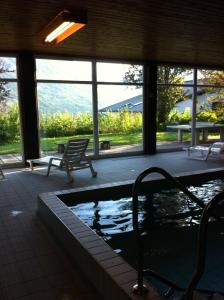 a swimming pool in a building with a view of the mountains at Dachsteinblick in Bad Aussee