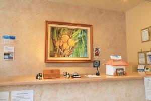 a counter with a picture of fruit on the wall at Seaside Hotel The Beach in Chatan