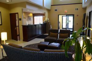 a lobby with a waiting room with couches and a waiting area at Best Western Joliet Inn & Suites in Joliet