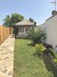 a backyard with a gazebo with a table and chairs at Sol de Bolonia 5 in Bolonia