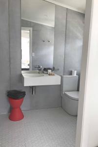 a bathroom with a sink and a toilet and a mirror at Byron Springs in Byron Bay +60 photos
