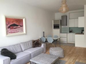 a living room with a couch and a table at Mariposa in Innsbruck