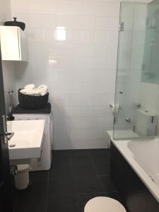 a bathroom with a sink and a toilet and a shower at Mariposa in Innsbruck