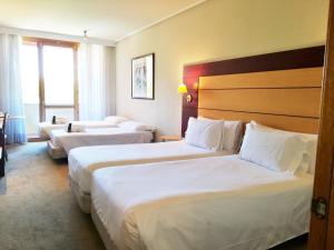A bed or beds in a room at Abba Garden