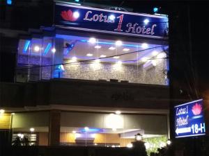 a building with a sign for a hotel at night at Lotus 1 Hotel in Lahore