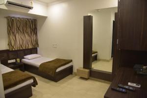 Uma cama ou camas num quarto em Hotel Alankar
