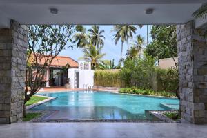 a swimming pool in the middle of a house at Triple O Six in Mirissa