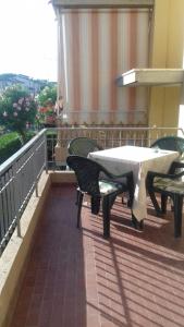 un patio con tavolo e sedie sul balcone. di Casa Ludovica a Lido di Camaiore