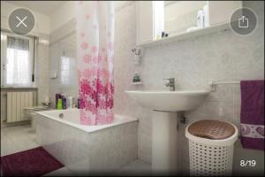 a bathroom with a sink and a shower curtain at Appartamento Serapo in Gaeta