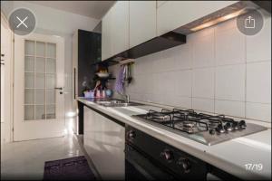 a kitchen with a stove and a counter top at Appartamento Serapo in Gaeta +6 photos
